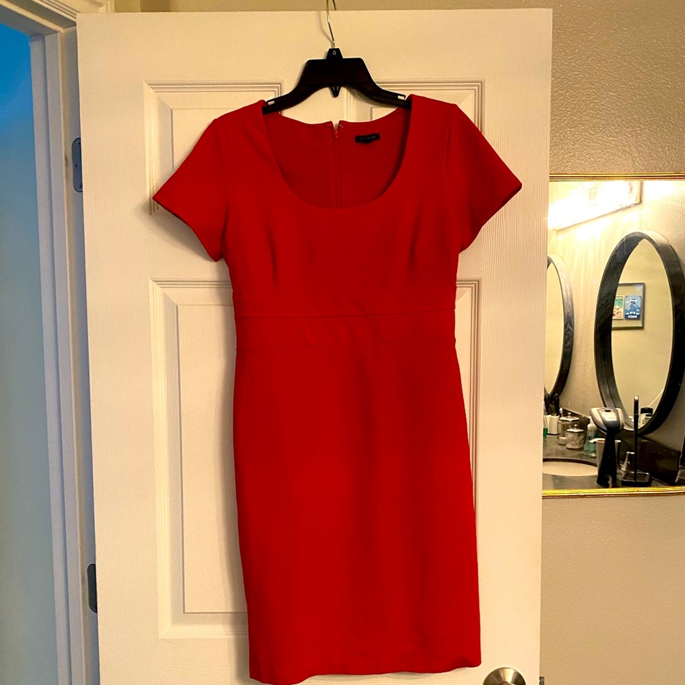 Cute, stretchy red orange dress. Sits above the knee.
